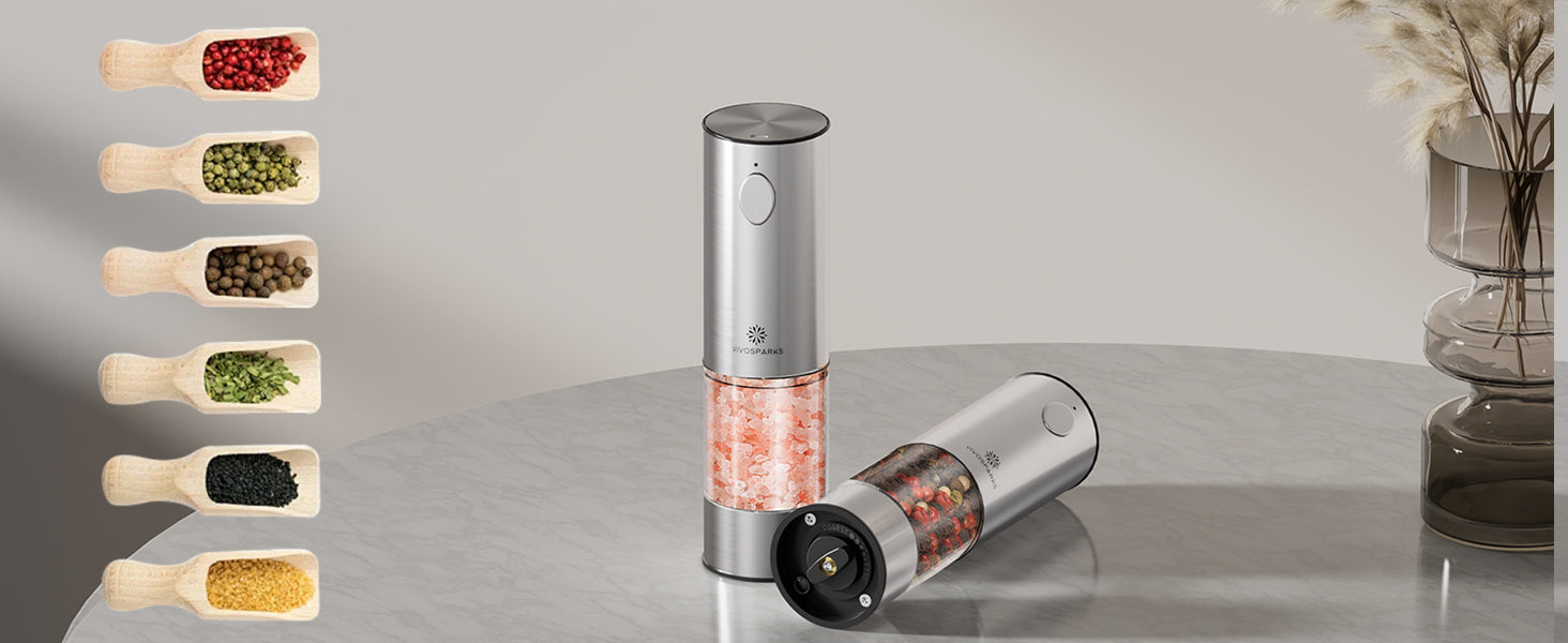 Electric pepper grinder with a selection of ground peppers on a neutral background