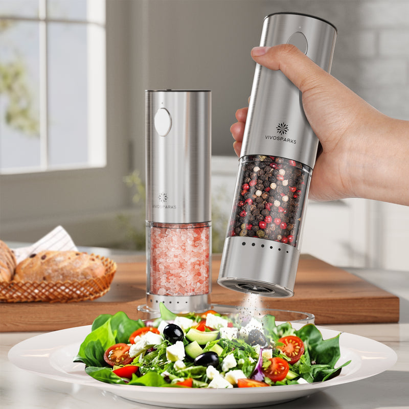 Vivospark salt and pepper shakers being used on a salad in a kitchen setting