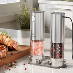 Two electric pepper mills on a kitchen counter with salt and pepper visible.
