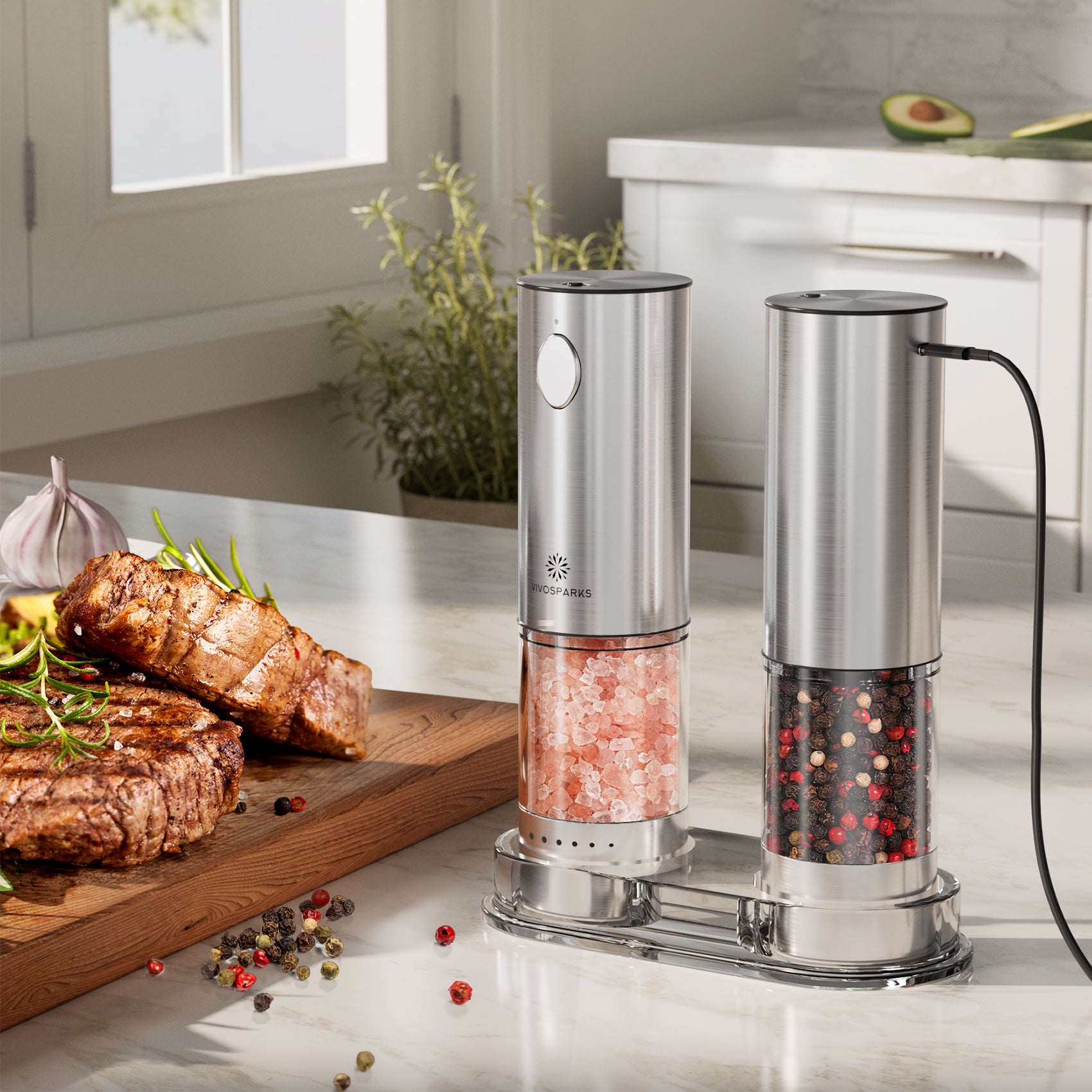 Two electric pepper grinders on a kitchen counter with cooked meat and spices.